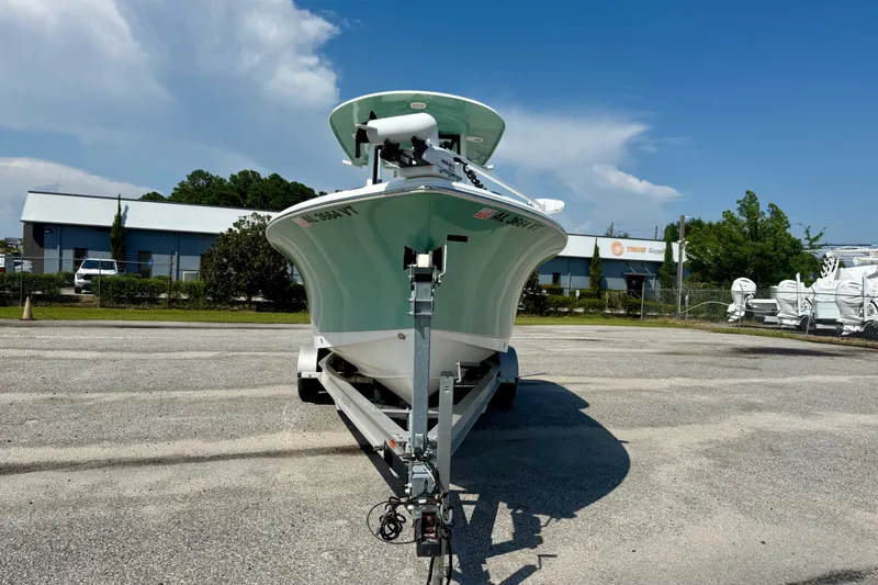 Slide: The Image of 2023 Sea Hunt Ultra 239SE boat on trailer in parking lot, clear sky background. - 2