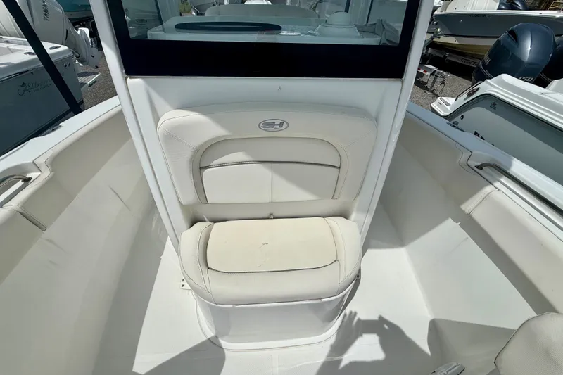 Slide: The Image of 2023 Sea Hunt Ultra 239SE boat interior with cushioned seating and sleek design. - 12