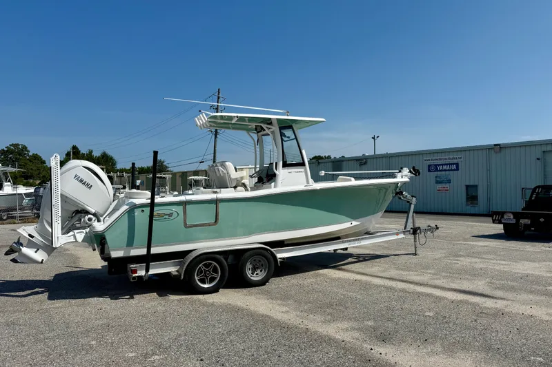 Slide: The Image of 2023 Sea Hunt Ultra 239SE boat on trailer, parked outside a Yamaha dealership. - 3