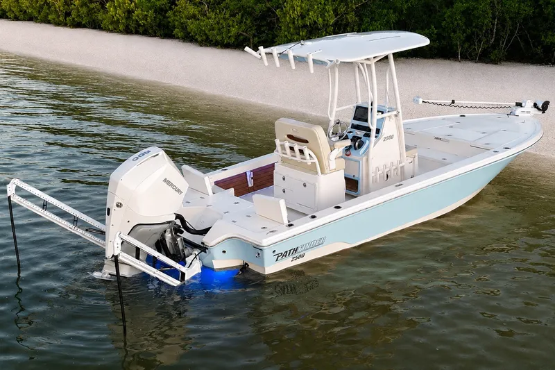 Slide: The Image of 2023 Pathfinder 2500 Hybrid boat in shallow water near a sandy shore. - 3
