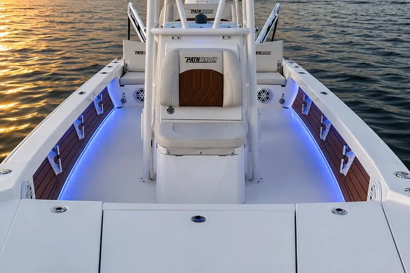 Slide: The Image of 2023 Pathfinder 2500 Hybrid boat interior with blue LED lighting on calm water. - 19