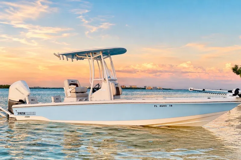 Slide: The Image of 2023 Pathfinder 2500 Hybrid boat on serene water at sunset. - 8