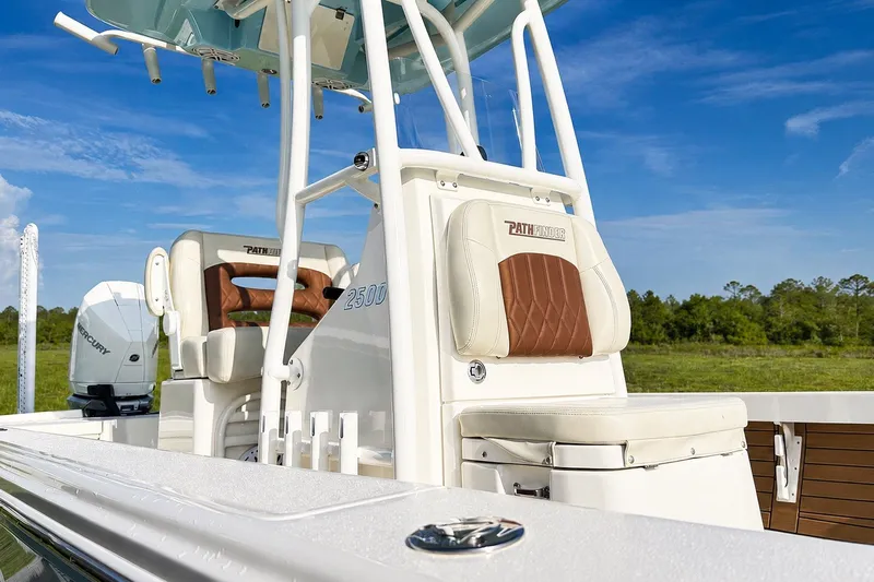 Slide: The Image of 2023 Pathfinder 2500 Hybrid boat interior with seating and Mercury engine, under clear blue sky. - 40