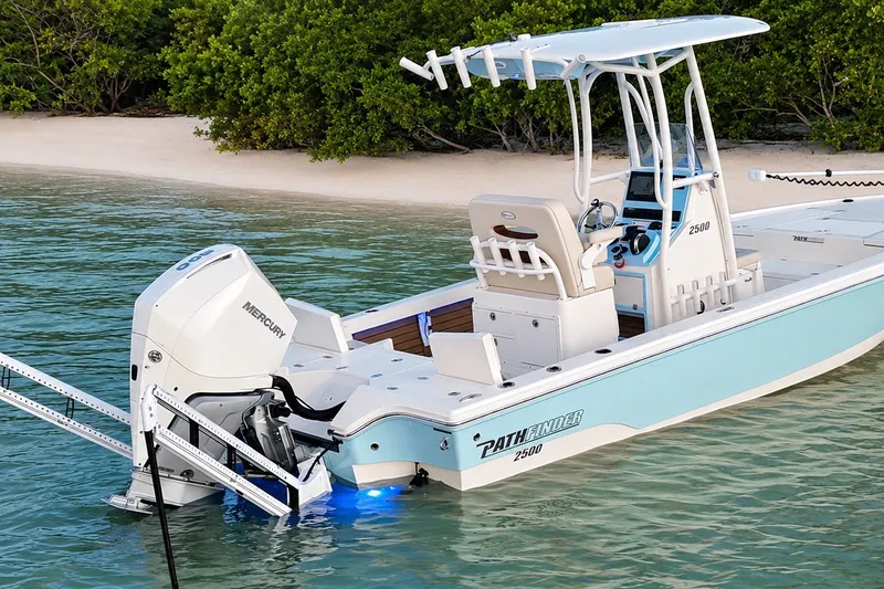 Slide: The Image of 2023 Pathfinder 2500 Hybrid boat with Mercury engine near a sandy beach. - 14