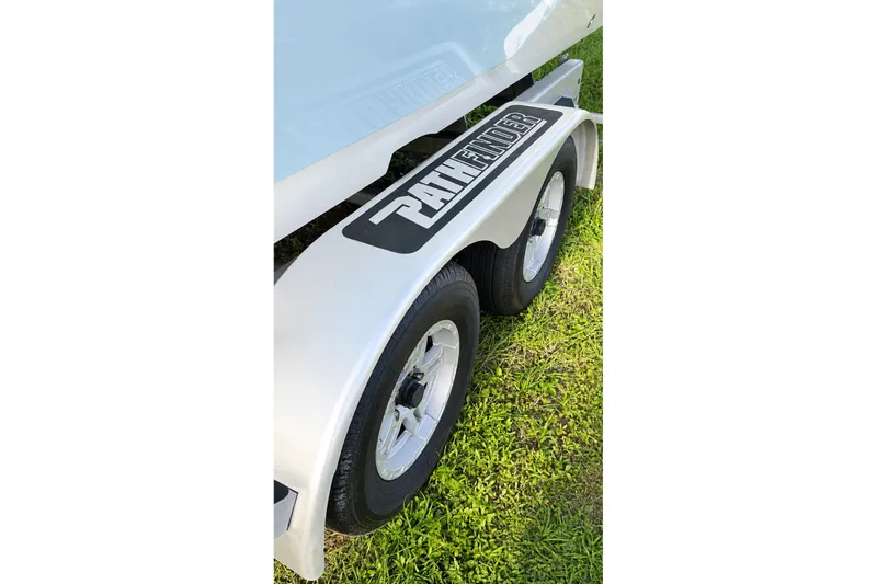 Slide: The Image of 2023 Pathfinder 2500 Hybrid trailer with dual wheels on grass. - 24