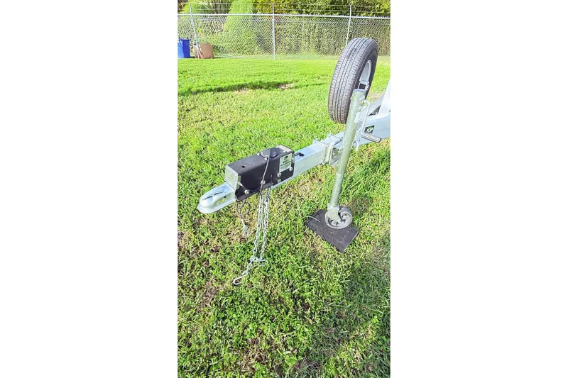 Slide: The Image of Trailer hitch and wheel on grass, part of a 2023 Pathfinder 2500 Hybrid. - 25