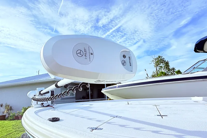 Slide: The Image of 2023 Pathfinder 2500 Hybrid boat with i-Pilot Riptide motor under a clear blue sky. - 34