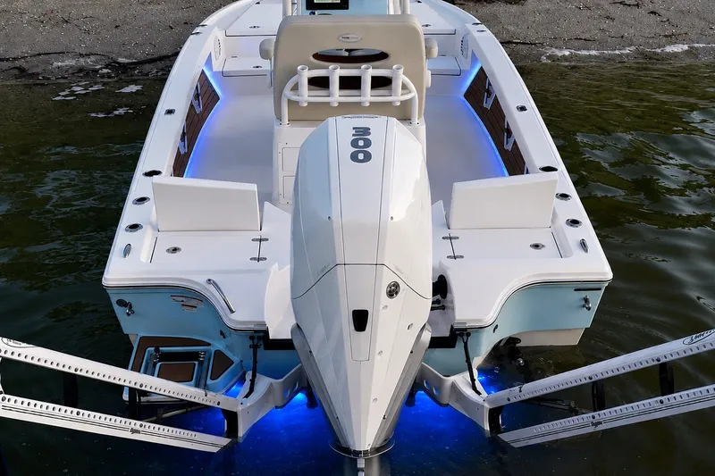 Slide: The Image of 2023 Pathfinder 2500 Hybrid boat with illuminated deck and powerful outboard motor. - 21