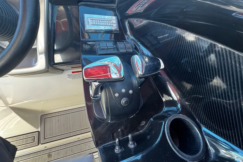 Slide: The Image of Control panel of a 2005 Cobolt 36 boat with steering wheel and throttle. - 14