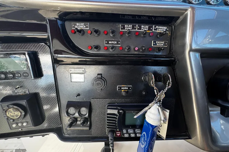 Slide: The Image of Control panel of a 2005 Cobolt 36 boat with switches and keys. - 15