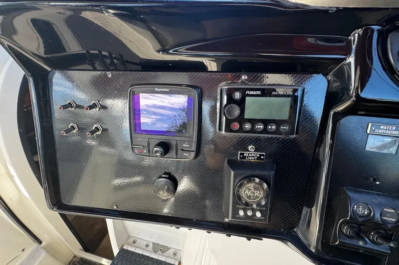 Slide: The Image of Control panel of a 2005 Cobolt 36 boat with navigation and audio systems. - 13