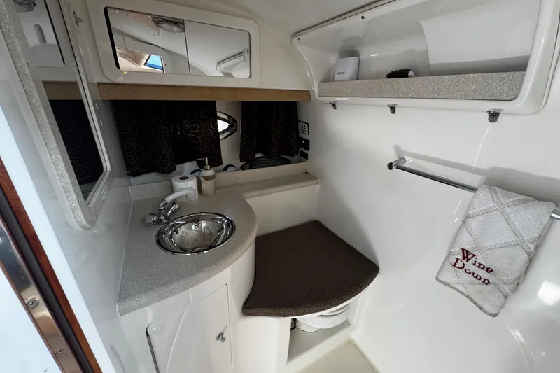 Slide: The Image of Compact bathroom in 2005 Cobolt 36 boat with sink, mirror, and towel rack. - 25