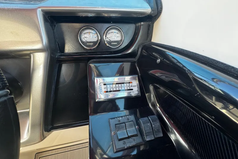 Slide: The Image of Dashboard of a 2005 Cobolt 36 boat with trim gauges and controls. - 12