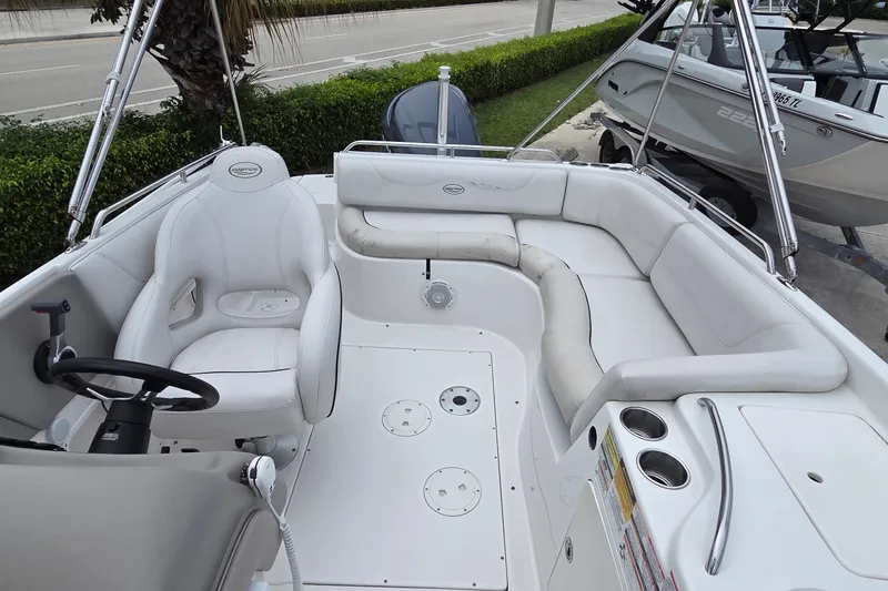 Slide: The Image of 2009 Ebbtide 2400 SS Fun Cruiser O/B with white seating and steering wheel. - 4