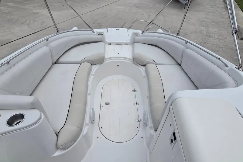 Slide: The Image of 2009 Ebbtide 2400 SS Fun Cruiser O/B boat interior with spacious seating and cup holder. - 6