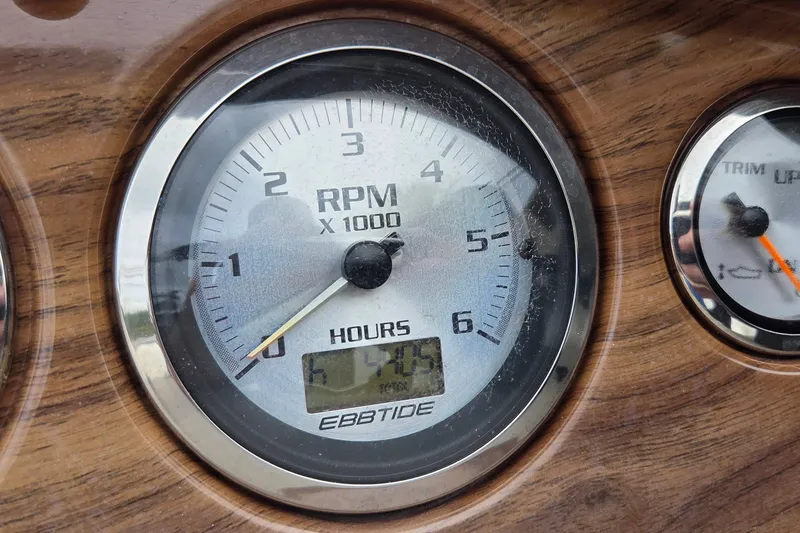 Slide: The Image of Close-up of 2009 Ebbtide 2400 SS Fun Cruiser RPM gauge displaying 1445 hours. - 7