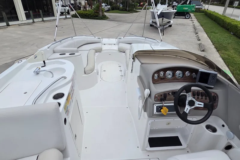 Slide: The Image of 2009 Ebbtide 2400 SS Fun Cruiser O/B boat interior with steering console and seating area. - 9