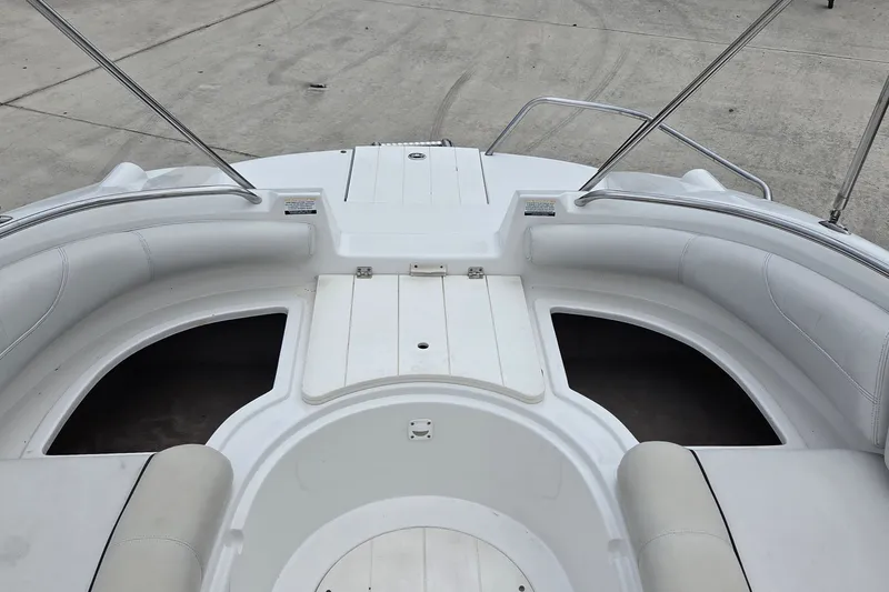 Slide: The Image of 2009 Ebbtide 2400 SS Fun Cruiser O/B boat interior with white seating and storage compartments. - 14