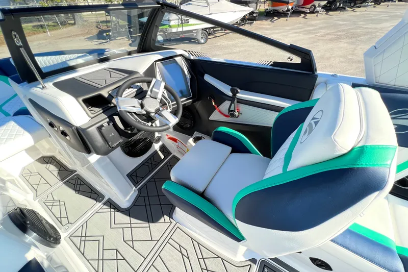 Slide: The Image of 2023 Tigé 21ZX boat interior with modern steering and seating design. - 5