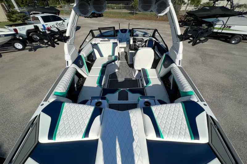 Slide: The Image of 2023 Tigé 21ZX boat interior with white and teal upholstery, spacious seating, and modern design. - 4
