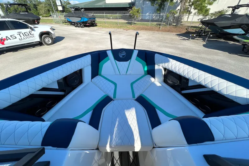 Slide: The Image of 2023 Tigé 21ZX boat interior with white and blue seating, green accents. - 6