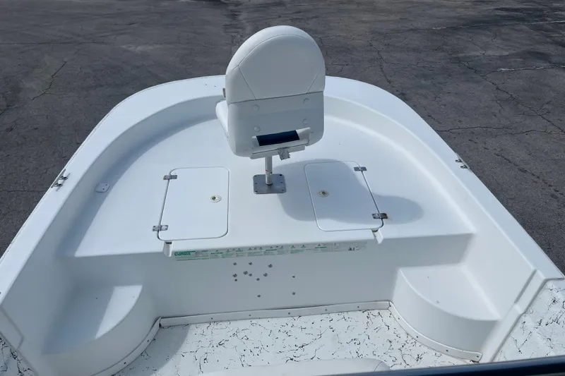 Slide: The Image of 2010 Sea Hunt Skiff 21 boat deck with white seat and storage compartments. - 13