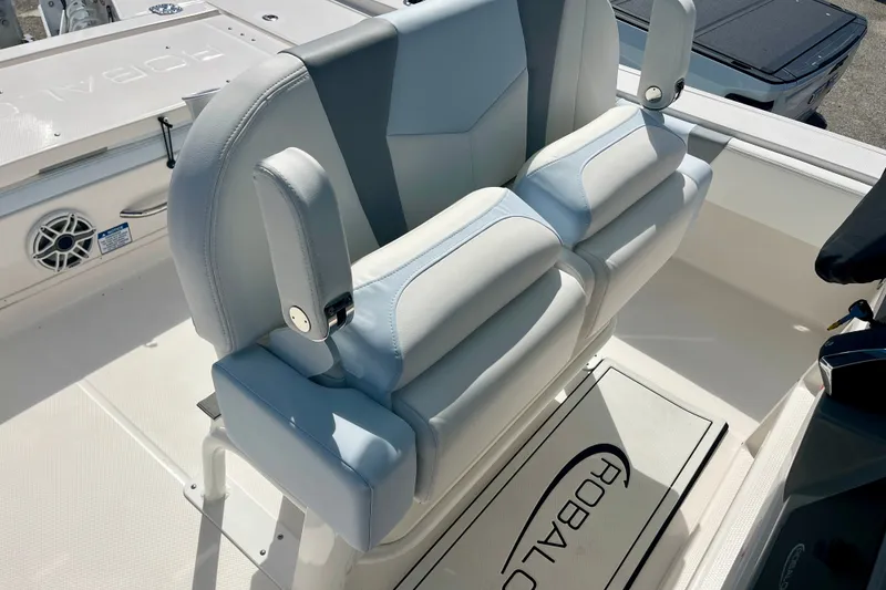 Slide: The Image of 2027 Robalo 266 Cayman boat seating with armrests and branded flooring. - 22
