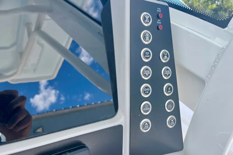 Slide: The Image of Control panel of 2027 Robalo 266 Cayman boat with various function buttons. - 25