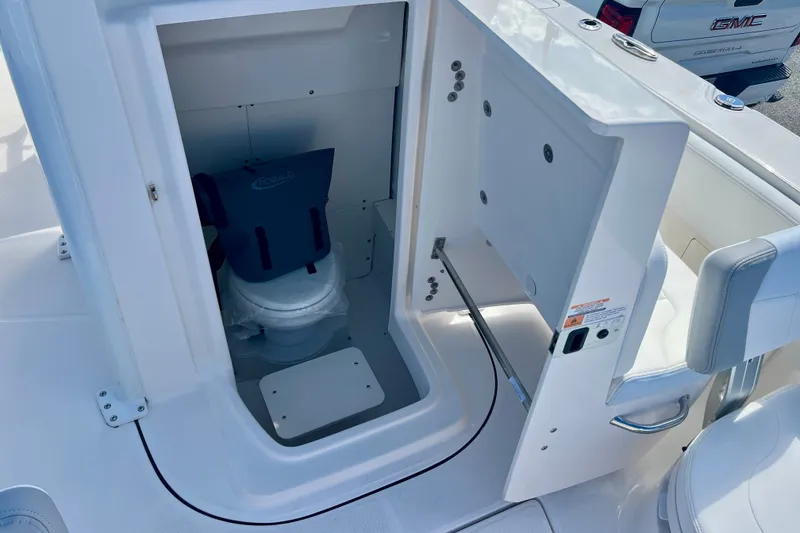 Slide: The Image of 2027 Robalo 266 Cayman boat interior storage compartment with seating and equipment. - 40