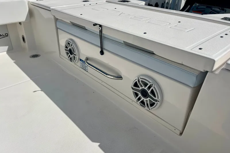 Slide: The Image of 2027 Robalo 266 Cayman boat interior with speakers and storage compartment. - 17