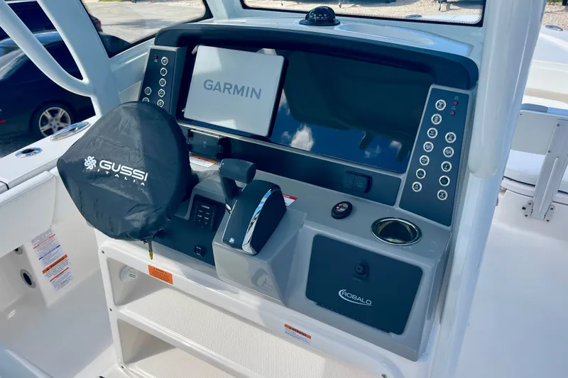 Slide: The Image of 2027 Robalo 266 Cayman boat dashboard with Garmin display and Gussi Italia steering wheel. - 23