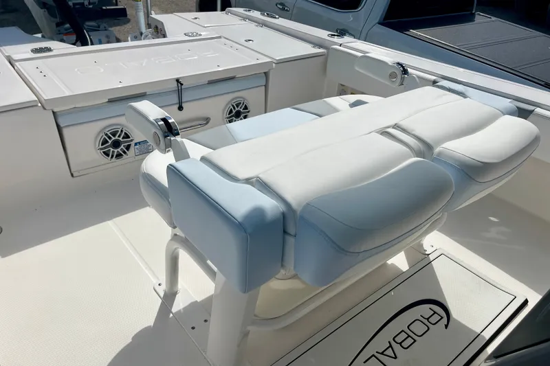Slide: The Image of 2027 Robalo 266 Cayman boat interior with cushioned seating and storage compartments. - 20