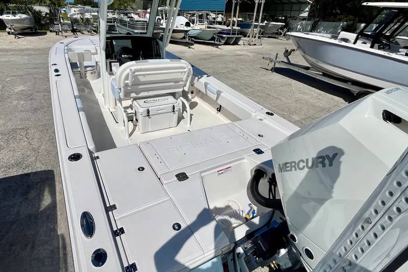 Slide: The Image of 2027 Robalo 266 Cayman boat with Mercury engine, docked in a marina. - 9