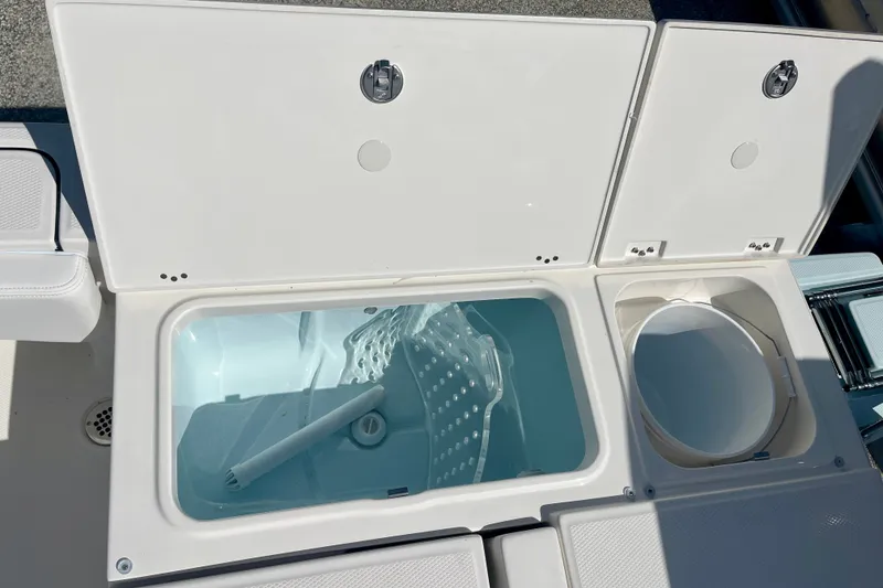 Slide: The Image of Livewell and storage compartments on a 2027 Robalo 266 Cayman boat. - 14