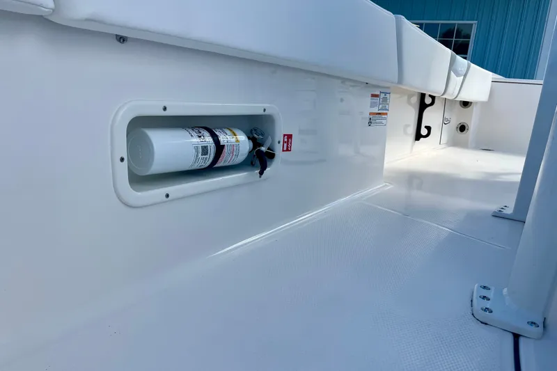 Slide: The Image of 2027 Robalo 266 Cayman boat deck with mounted fire extinguisher. - 37
