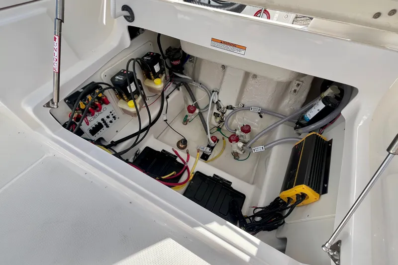 Slide: The Image of Electrical compartment of 2027 Robalo 266 Cayman boat, showcasing wiring and components. - 16