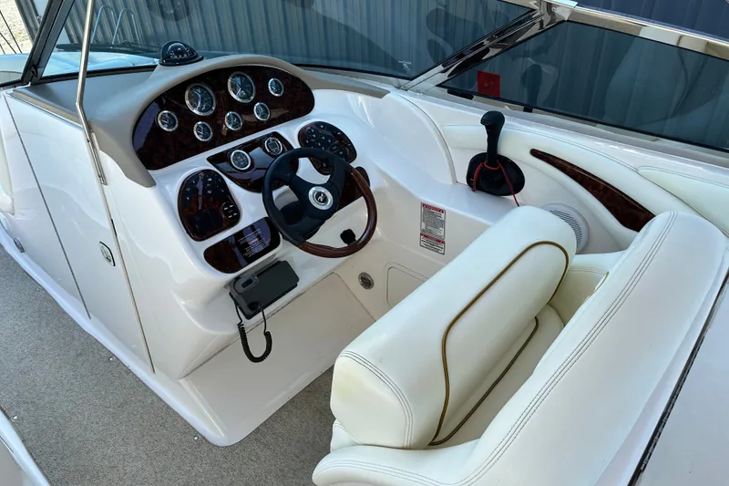 Slide: The Image of 2001 Sea Ray 290 Bowrider cockpit with steering wheel and instrument panel. - 11
