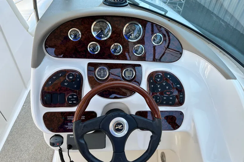 Slide: The Image of Dashboard of a 2001 Sea Ray 290 Bowrider with wood accents and gauges. - 12