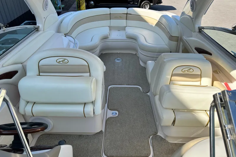 Slide: The Image of 2001 Sea Ray 290 Bowrider interior with luxurious white seating and spacious layout. - 16