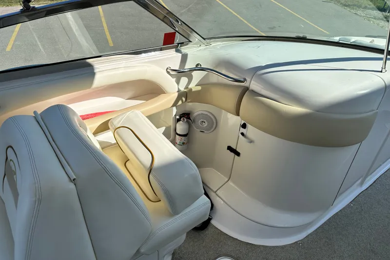 Slide: The Image of Interior of a 2001 Sea Ray 290 Bowrider boat with white seating and dashboard. - 10