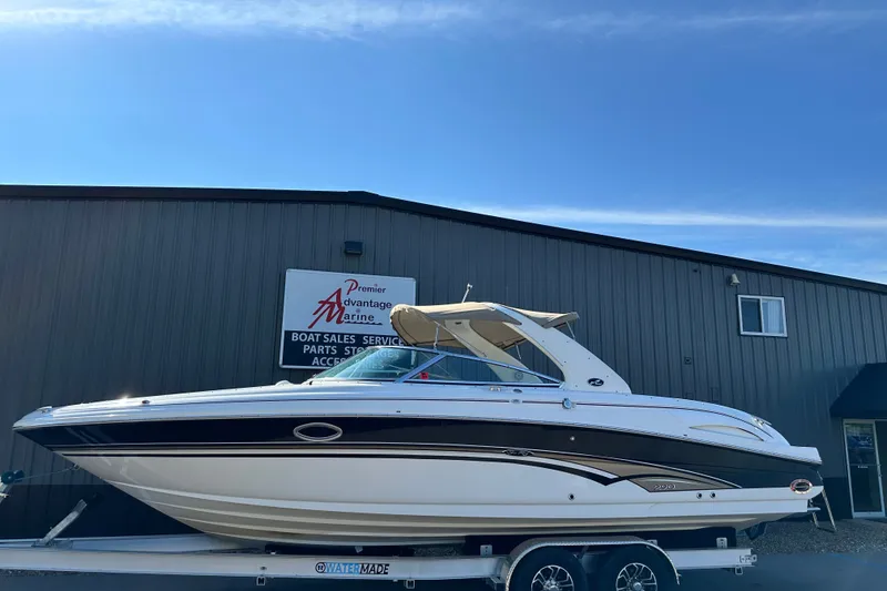 Slide: The Image of 2001 Sea Ray 290 Bowrider on trailer outside marine dealership. - 1