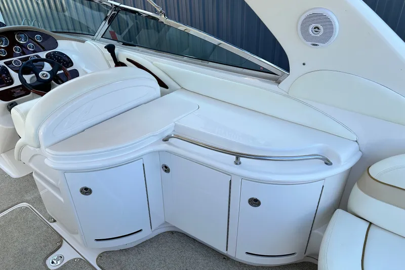Slide: The Image of 2001 Sea Ray 290 Bowrider interior with white seating and control panel. - 8