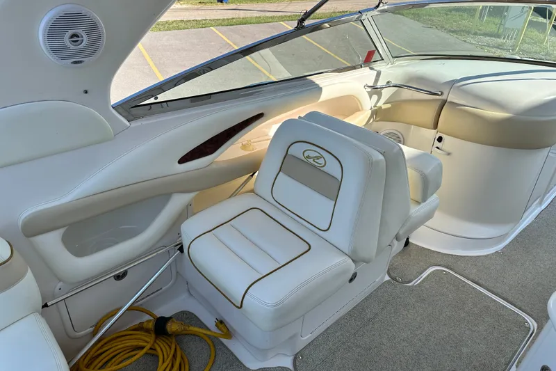 Slide: The Image of Interior of a 2001 Sea Ray 290 Bowrider with white seating and dashboard. - 7