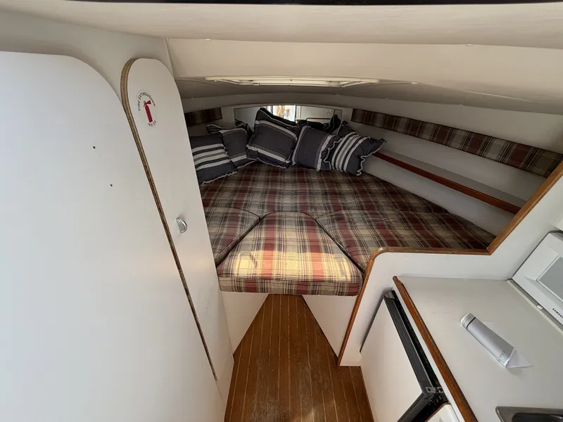 Slide: The Image of Cabin with cozy bed and plaid pillows, wooden floor, and white interior. - 16