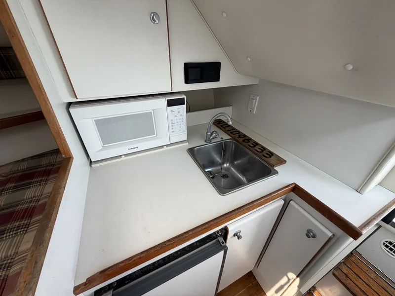 Slide: The Image of Compact kitchenette with sink, microwave, and countertop in a yacht. - 18
