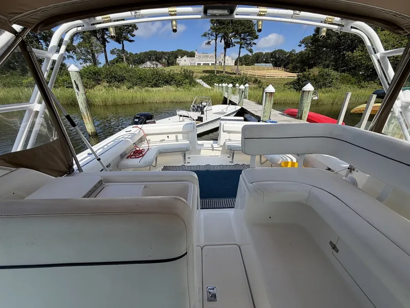 Slide: The Image of The image shows the cockpit of a 2000 Tiara Yachts 2900 Coronet, featuring white seating and a dock in the background. - 15