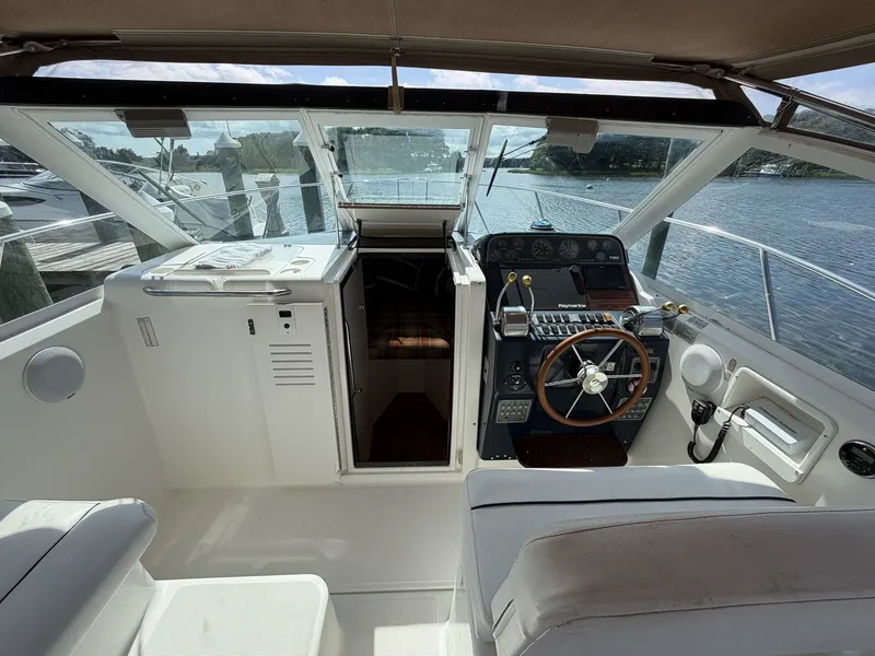 Slide: The Image of The cockpit of a 2000 Tiara Yachts 2900 Coronet with helm and seating area. - 14
