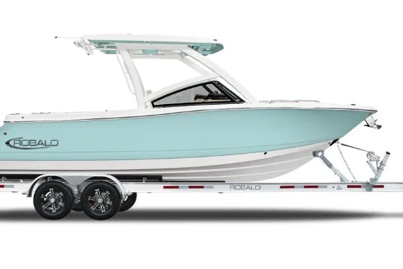 The Image of 2027 Robalo R277 Dual Console boat on trailer, side view, light blue hull. - 2