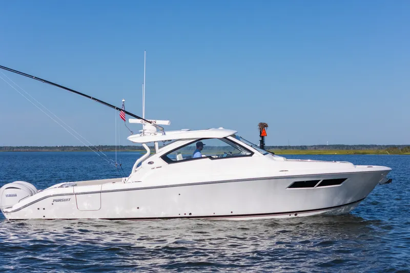 Slide: The Image of 2021 Pursuit DC 365 Dual Console boat cruising on open water. - 6
