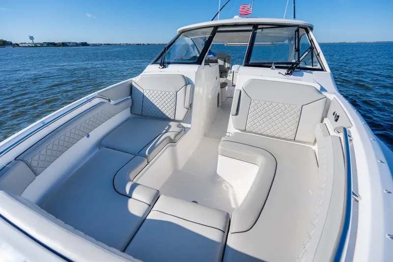Slide: The Image of 2021 Pursuit DC 365 Dual Console boat with spacious seating on open water. - 40